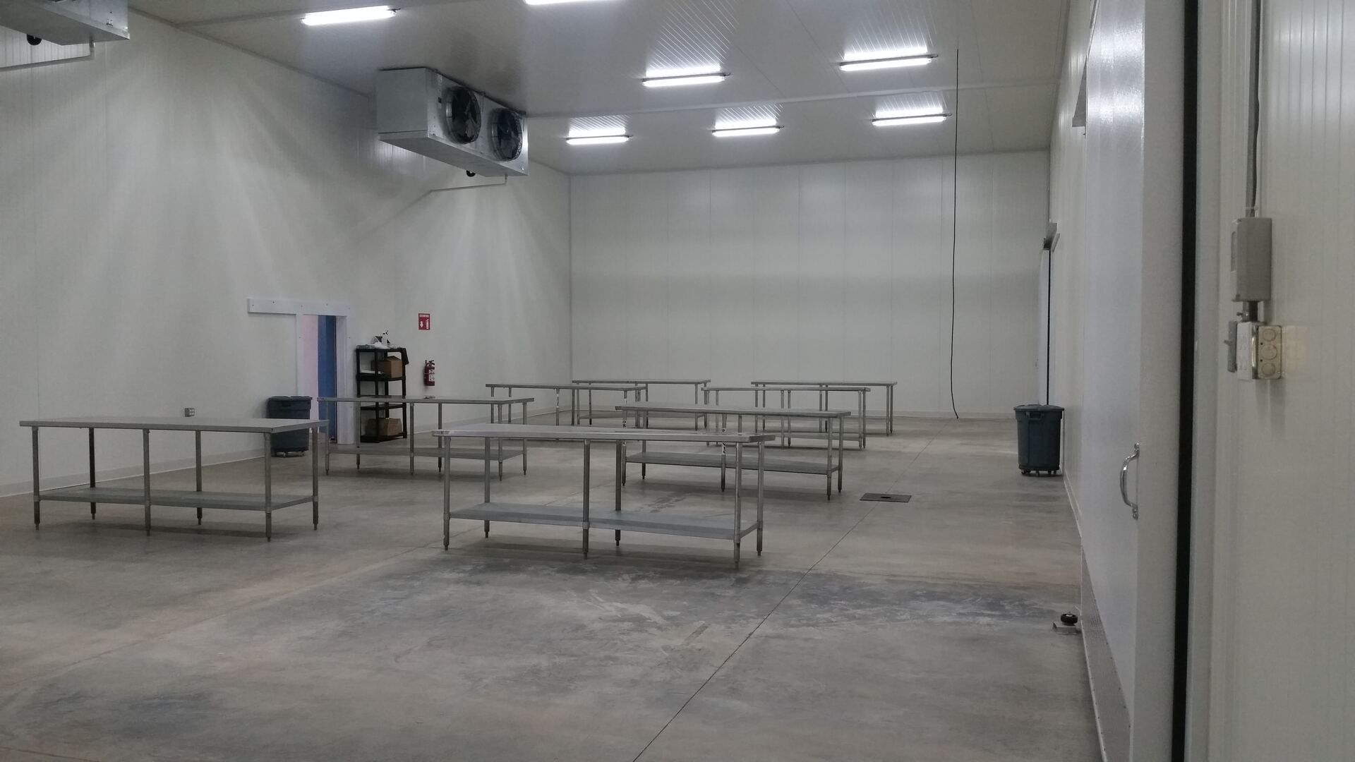 Interior of a refrigerated packing room with stainless steel tables